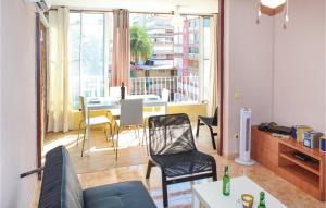 a living room with a couch and a table with chairs at Cozy Apartment In Alicante With Wifi in Alicante