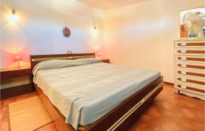 a bedroom with a large bed and a dresser at Calabria G41 in Lido di Pomposa