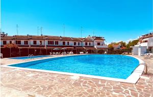 a large blue swimming pool in front of a building at Calabria G41 in Lido di Pomposa