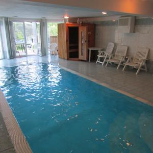a swimming pool with blue water in a house at Villa Vranov 55 in Čerčany