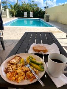 a plate of food on a table next to a cup of coffee at 2bedroom mountain view villa #2 in Muñoz