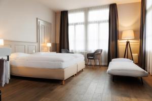 En eller flere senger på et rom på Hotel Emmental