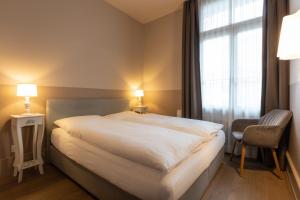En eller flere senger på et rom på Hotel Emmental