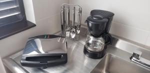 a kitchen sink with a blender and a mixer at Apartamento La Floresta con todas las comodidades in Bogotá