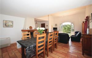 a kitchen and living room with a table and chairs at 4 Bedroom Awesome Home In Roquebrun in Roquebrun