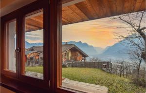 a window with a view of a house at Il Casotto in Telve
