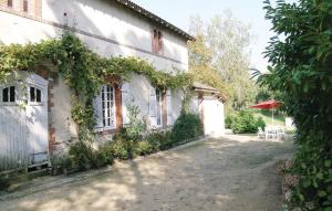 a house with ivy growing on the side of it at Nice Home In La Chapelle Hermier in La Chapelle-Hermier