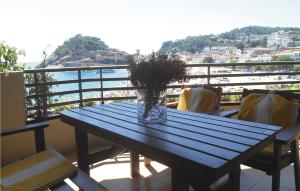 a blue table on a balcony with a view of the water at Nice Apartment In Tossa De Mar in Tossa de Mar +28 photos