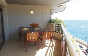 a balcony with a table and chairs and the ocean at Nice Apartment In Tossa De Mar in Tossa de Mar