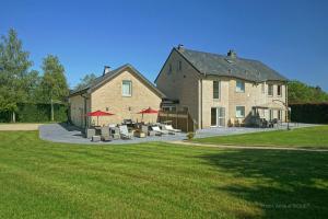 a large house with a yard with chairs and tables at Résidence Dolce Vita in Waimes