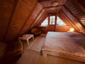 a bedroom with a large bed in a attic at Ferienhaus Maria in Mönkebude