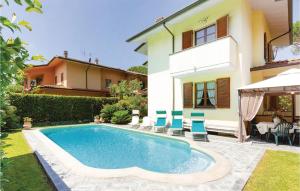 a swimming pool in front of a house at Villa Anna in Camaiore