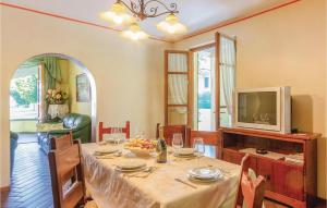 a dining room with a table and a tv at Villa Anna in Camaiore