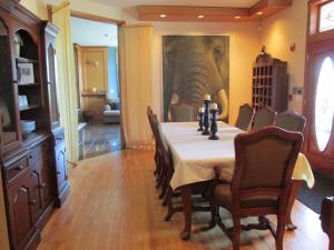 a dining room with a table and an elephant painting at Mansion Inn Lake Stevens in Lake Stevens