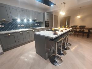 a large kitchen with a island in the middle at 4 BR Luxury House. Bike Park Wales. Secure Bike Store. Brecon Beacons in Dowlais