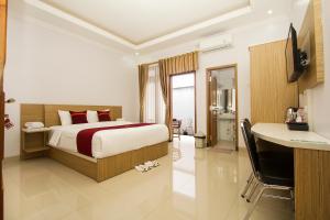 Ένα ή περισσότερα κρεβάτια σε δωμάτιο στο Banua Raya Homestay