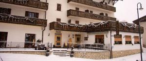 a building with snow on the balconies of it at Hotel Due Spade in Folgaria
