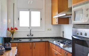 a kitchen with a sink and a stove top oven at Beautiful Apartment In Tossa De Mar in Tossa de Mar