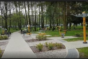 a park with a playground with tables and benches at Wici 2 Apartments Teofilow Wodny Raj in Teofilów