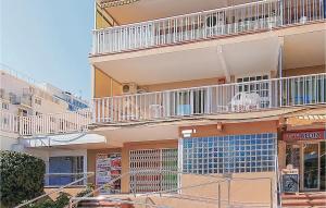 a building with balconies and tables and chairs at Awesome Apartment In Malgrat De Mar in Malgrat de Mar +18 photos