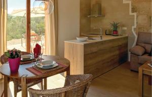 a kitchen and dining room with a table and a sink at Nice Home In Son Carrió With Wifi in Son Carrió