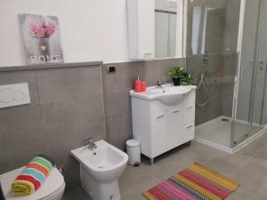 a bathroom with a toilet and a sink and a shower at Bnbook Casa Beatrice Appartamento con 2 camere Gallarate in Gallarate +17 photos
