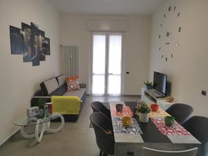 a living room with a couch and a table at Bnbook Casa Beatrice Appartamento con 2 camere Gallarate in Gallarate