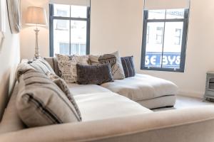 - un salon avec un canapé et 2 fenêtres dans l'établissement Bryan Street Apartments, à Ballymena