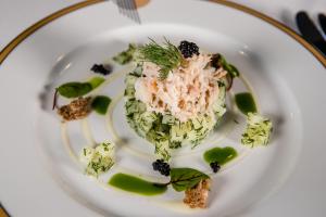 a white plate with food on a table at Burgh Island Hotel in Bigbury on Sea