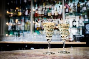 two wine glasses sitting on a table in a bar at Burgh Island Hotel in Bigbury on Sea