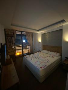 a bedroom with a large bed with flowers on it at MİYAS LUXURY HOTEL in Kemer