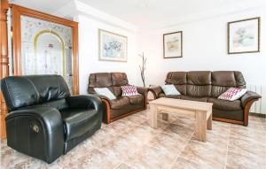 a living room with leather furniture and a table at Nice Apartment In Santa Pola in Santa Pola