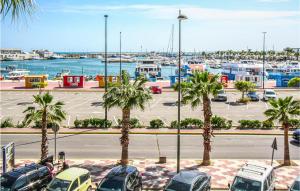 a parking lot with palm trees and a marina at Nice Apartment In Santa Pola in Santa Pola +18 photos
