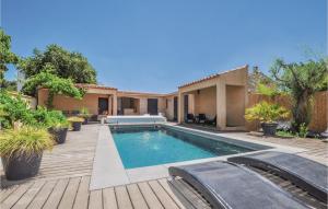 a swimming pool in the backyard of a house at 4 Bedroom Awesome Home In Narbonne in Narbonne