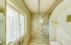 a bathroom with a shower and a toilet and a window at Gorgeous Apartment In Golfo Aranci With Kitchenette in Golfo Aranci