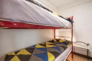 a bunk bed with a colorful quilt on the bottom bunk at Casa Heli II in San Zeno di Montagna