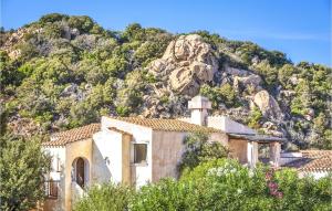 a house in front of a mountain at Bilo 4 in Porto Cervo