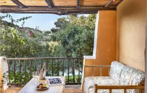 a room with a balcony with a table and a chair at Bilo 4 in Porto Cervo