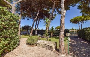 a park with a bench next to a tree at Villa Arduino in Santa Liberata +17 photos