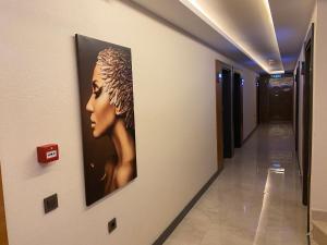 a picture of a woman on a wall in a hallway at MİYAS LUXURY HOTEL in Kemer