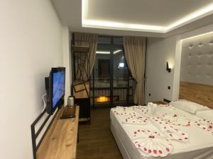 a bedroom with a bed with flowers on it at MİYAS LUXURY HOTEL in Kemer