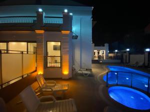 a house with a swimming pool at night at MİYAS LUXURY HOTEL in Kemer