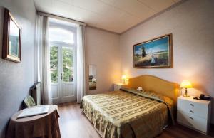Postel nebo postele na pokoji v ubytování Hotel Maderno