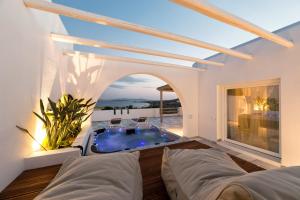 a villa with a swimming pool in a living room at Paros Agnanti Resort & Spa in Parikia