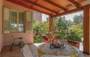 a patio with a table and two bikes on a porch at La Pineta in Lido Signorino