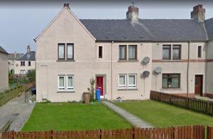 a large white house with a red door at Carvetii - Vincent House - Large 3 bedroom apartment with on-site parking in Fife