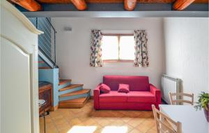een woonkamer met een rode bank en een raam bij La Gallina in Artogne