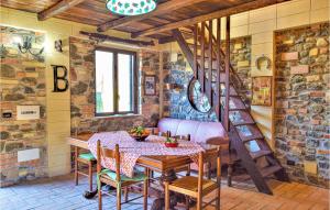a dining room with a table and a spiral staircase at Stunning Home In Palmi With Wifi in Palmi