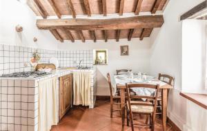 a kitchen with a table and a stove top oven at Casa Samuele in Polvano
