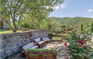 a stone retaining wall with benches and a stone wall at Casa Samuele in Polvano